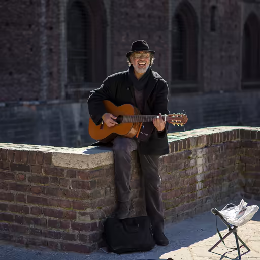 Real photo: Man playing guitar on the street
